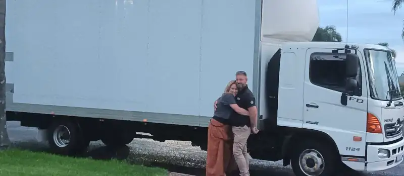 Nathan and Cassandra of NCG Movers together beside one of their trucks