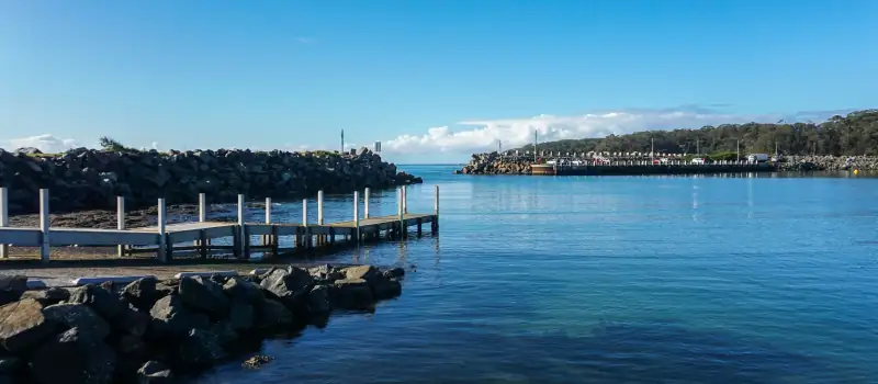 Ulladulla Harbour with the jetty and the fishing fleet